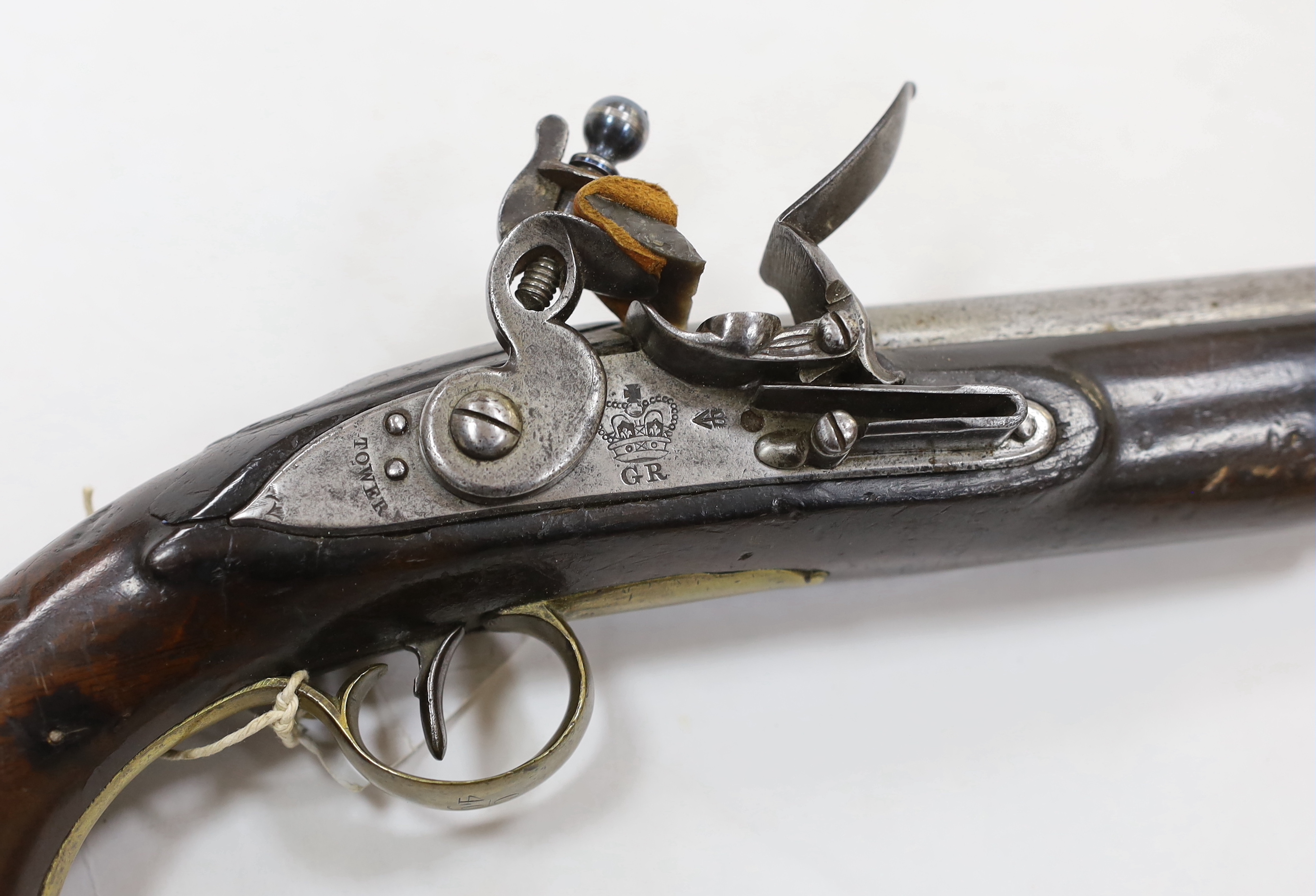 A 16 bore New Land Pattern flintlock service pistol with regulation lock engraved with crowned GR, Tower proofed barrel, fitted with regulation brass mounts and swivel ramrod